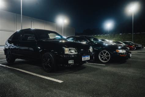 A Black Car Is Parked In A Parking Lot