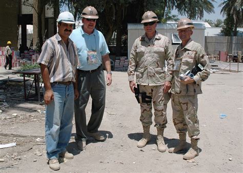 An Iraq Construction Contractor Poses For A Photograph With Us Army