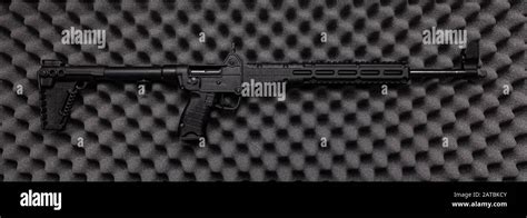 Modern Tactical Carbine On A Gray Foam Rubber Background Weapons For