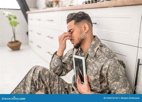 Sad Army Soldier Holding The Framed Photograph In The Hand Stock Image