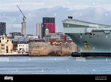 The Royal Navy Aircraft Carrier Hms Queen Elizabeth R08 Passes The Round Tower At The Entrance