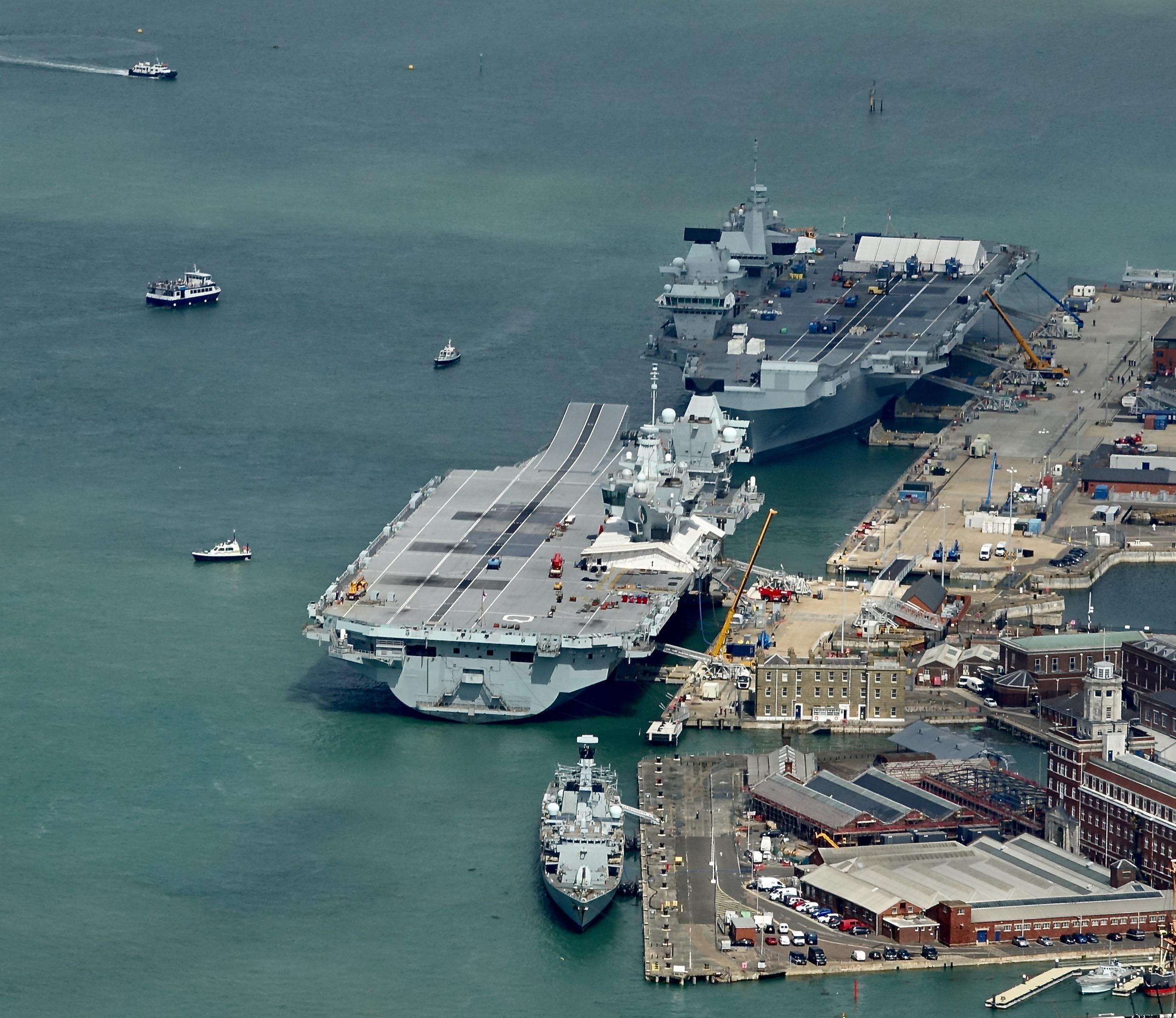 The Royal Navy S Two Aircraft Carriers Face Each Other Alongside At